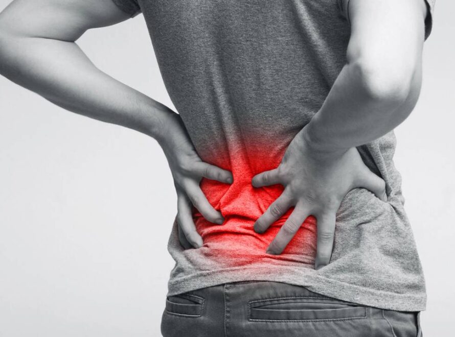 Homem segurando as costas enquanto sofre com dor lombar