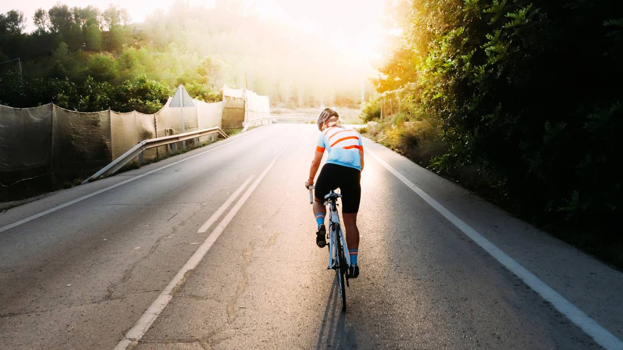 Ciclista pedalando sozinho na via